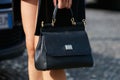 Woman with black leather Dolce and Gabbana bag before Gabriele Colangelo fashion show, Milan Fashion Week