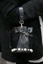 Woman with black leather Fendi bag with pearls decoration before Emporio Armani fashion show,