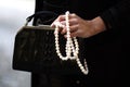 Woman in black with pearls and an antique alligator purse hand detail Royalty Free Stock Photo