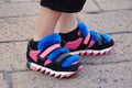 Woman with black, pink Dolce Gabbana shoes with blue fur before Salvatore Ferragamo fashion show, Milan