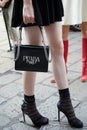 Woman with black Prada leather bag with silver chain before Peter Pilotto fashion show, Milan
