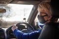 Woman in black protective mask and sunglasses inside a car