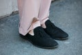 Woman with black shoes and pink trousers before N 21 fashion show, Milan Fashion Week street style on January