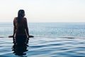 Woman black silhouette at infinity swimming pool Royalty Free Stock Photo