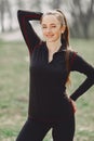 Elegant woman in a black uniform in a spring park Royalty Free Stock Photo