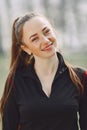 Elegant woman in a black uniform in a spring park Royalty Free Stock Photo