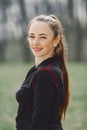 Elegant woman in a black uniform in a spring park Royalty Free Stock Photo