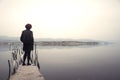 Woman in black standing on jetty