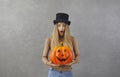 Woman with Halloween pumpkin looking at camera with shocked, scared face expression Royalty Free Stock Photo