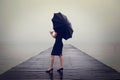 Woman with black umbrella looking infinity in a surreal place Royalty Free Stock Photo