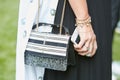 Woman with black and white Patrizia Pepe bag before Giorgio Armani fashion show, Milan Fashion Week street Royalty Free Stock Photo