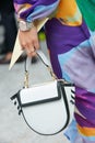 Woman with black and white Wandler bag and Rolex watch with pink dial before Sportmax fashion