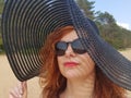 Woman in a black wide-brimmed hat and sunglasses portrait Royalty Free Stock Photo