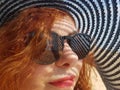 Woman in a black wide-brimmed hat and sunglasses portrait Royalty Free Stock Photo