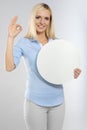 Woman with blank board and showing okay gesture