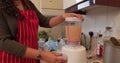 Woman blending vegetables while cooking