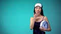 Woman in blindfold holding clock and yawning, late for work, sleeping disorder