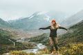 Woman bliss emotional raised hands foggy mountains