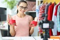 Woman blogger makes video review on red sandals closeup Royalty Free Stock Photo