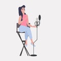 Woman blogger recording music video blog in studio podcasting broadcasting online radio concept girl singing to Royalty Free Stock Photo