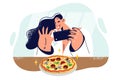 Woman blogger takes picture of pizza on phone to post review and tell followers about new pizzeria