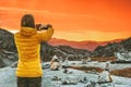 Woman blogger taking photo by smartphone of sunset mountains