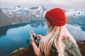 Woman blogger using smartphone navigation application traveling in Norway digital nomad girl hiking with backpack