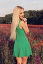 Woman with blond hair in elegant dress posing at summer blossom lavender field Royalty Free Stock Photo