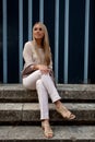 Woman sitting stairs medieval Romanesque door Royalty Free Stock Photo