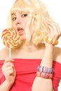 Woman in blond wig with lollipop Royalty Free Stock Photo