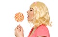 Woman in blond wig with lollipop Royalty Free Stock Photo