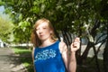 Woman blonde in blue dress walking along a city street against a background of urban architecture and summer Siberian beauties Royalty Free Stock Photo