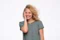 Woman with blonde curly hair smiling and laughing with wind effect Royalty Free Stock Photo