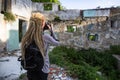 Woman with blonde dreadlocks takes pictures of Abandoned buildings. Royalty Free Stock Photo