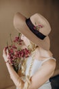 Woman blonde gray dress flowers hat Royalty Free Stock Photo