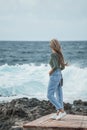 Woman with blonde hair looking at the infinity the sea