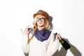 Woman, blonde and hat with champagne of nerd, geek or hipster thinking against a studio background. Attractive female Royalty Free Stock Photo