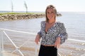 Woman blonde smiling happy beauty portrait in coast side outdoors in summer day Royalty Free Stock Photo