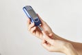 Woman with blood glucose meter, close-up