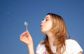 Woman blow a dandelion