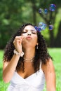 Woman blowing bubbles