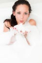 Woman blowing bubbles of foam bath in the tub Royalty Free Stock Photo