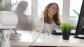 Woman blowing a fan in the office, Dehydration, heatstroke, office worker suffering from summer heat