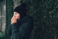 Woman blowing her nose into paper handkerchief Royalty Free Stock Photo