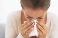 Woman blowing nose into handkerchief Royalty Free Stock Photo