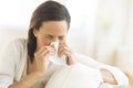 Woman Blowing Nose With Tissue At Home Royalty Free Stock Photo