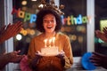 Woman blowing out her birthday candles and celebrating Birthday Royalty Free Stock Photo