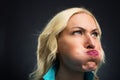 Woman blowing out her cheeks Royalty Free Stock Photo