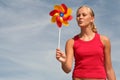 Woman Blowing Pinwheel Royalty Free Stock Photo