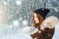 Woman blowing snow. Young woman at winter. Winter young woman portrait. Beautiful young woman laughing outdoors. Enjoying nature, Royalty Free Stock Photo